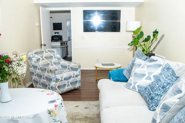 a dining room with furniture and wooden floor