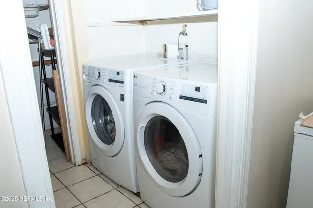 a bedroom with a bed a chair and a large window