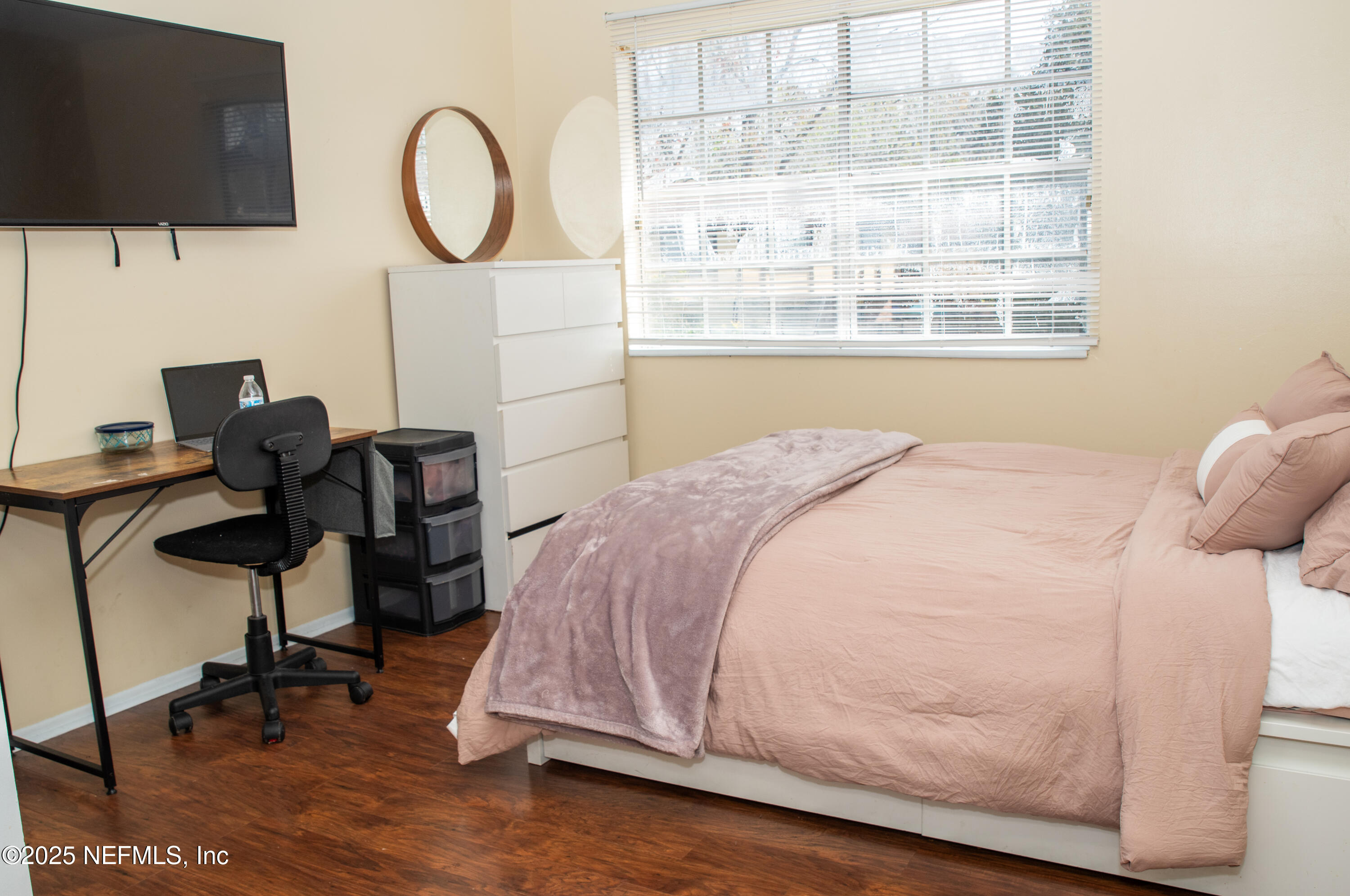 4822 Windrush Lane Jacksonville, FL 32217 - Photo 9 of 13 a bedroom with a bed a chair and a large window