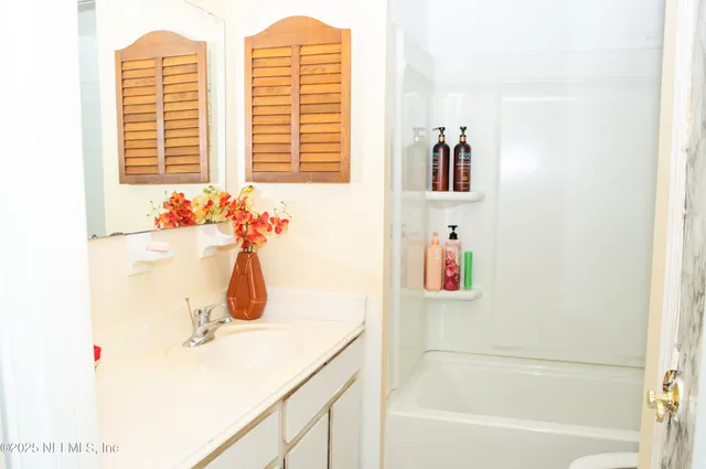 a bedroom with a bed and a desk