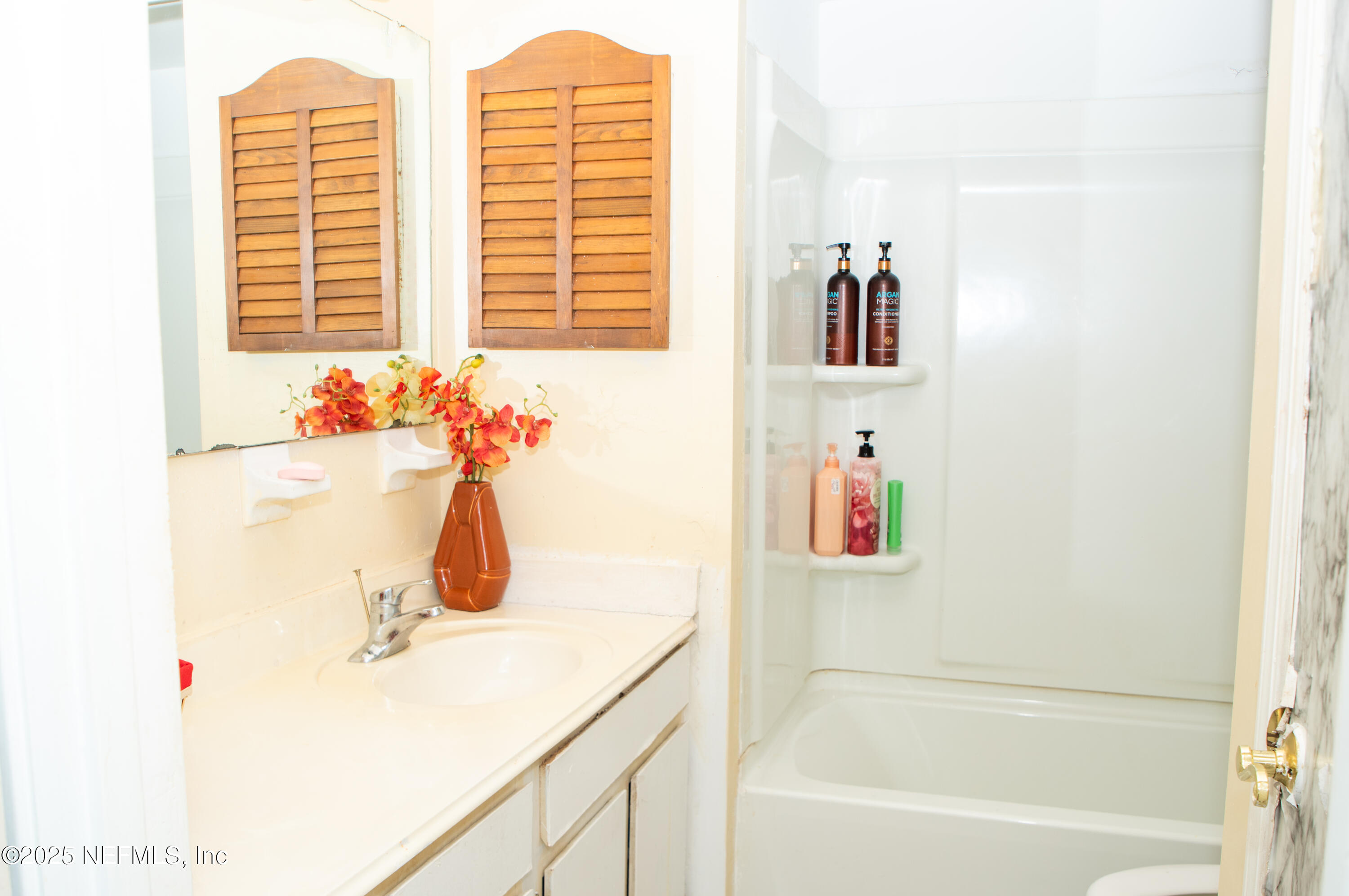 4822 Windrush Lane Jacksonville, FL 32217 - Photo 10 of 13 a bathroom with a tub sink and a window