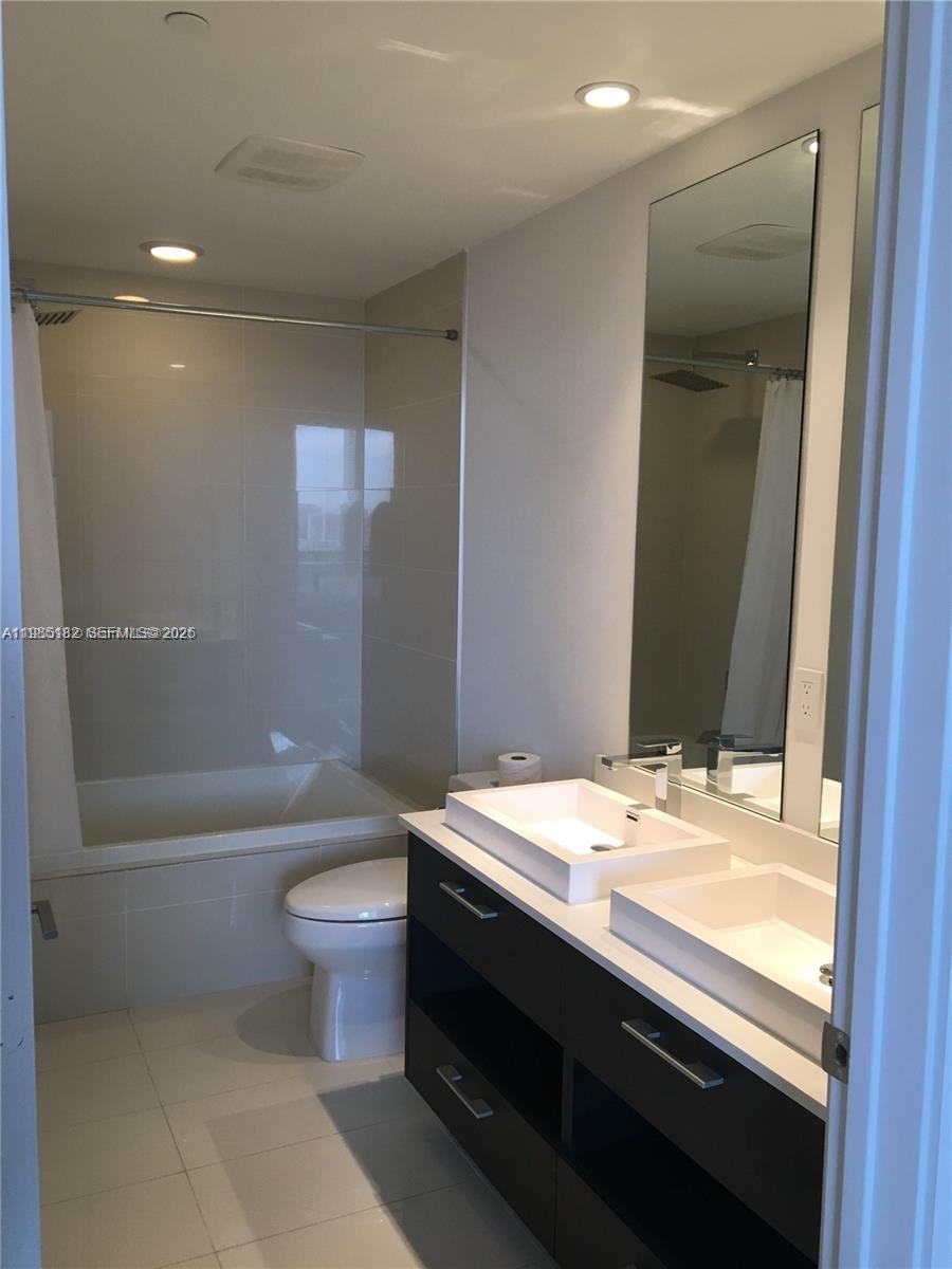 55 Southwest 9th Street, Unit 2901 Miami, FL 33130 - Photo 15 of 20 a bathroom with a sink a toilet and bathtub