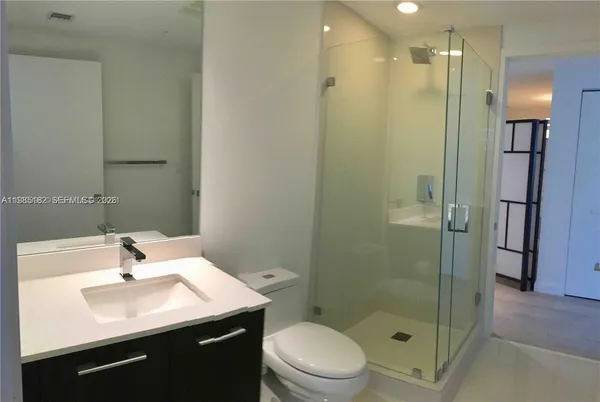 a bathroom with a sink toilet and shower