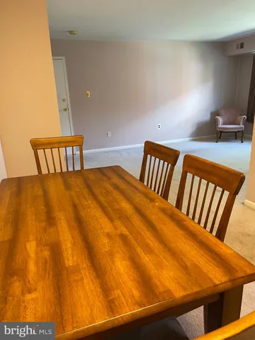 a kitchen with a wooden floor and a refrigerator
