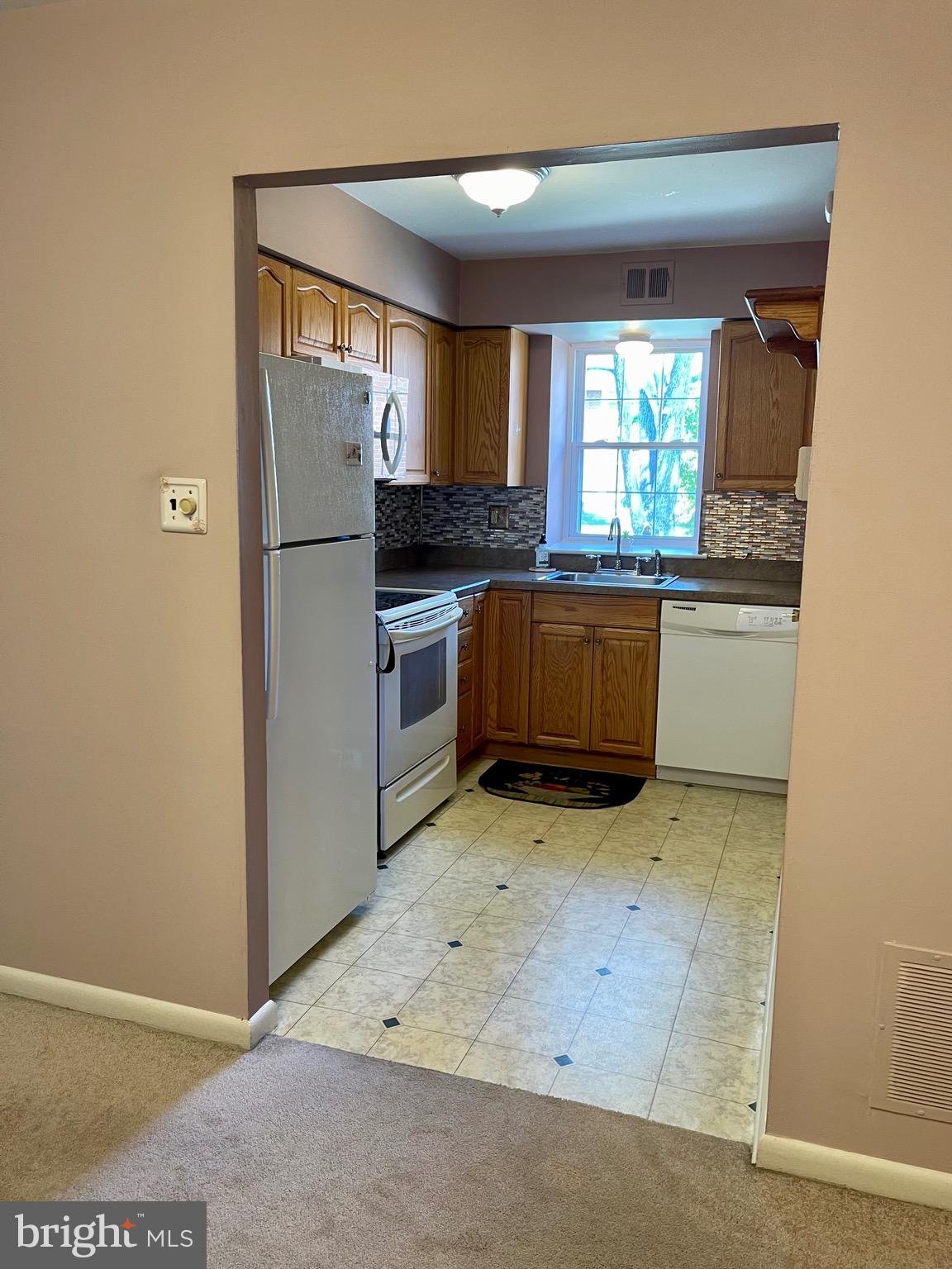 804 South Avenue, Unit D7 Secane, PA 19018 - Photo 14 of 33 a kitchen with stainless steel appliances a stove and a refrigerator