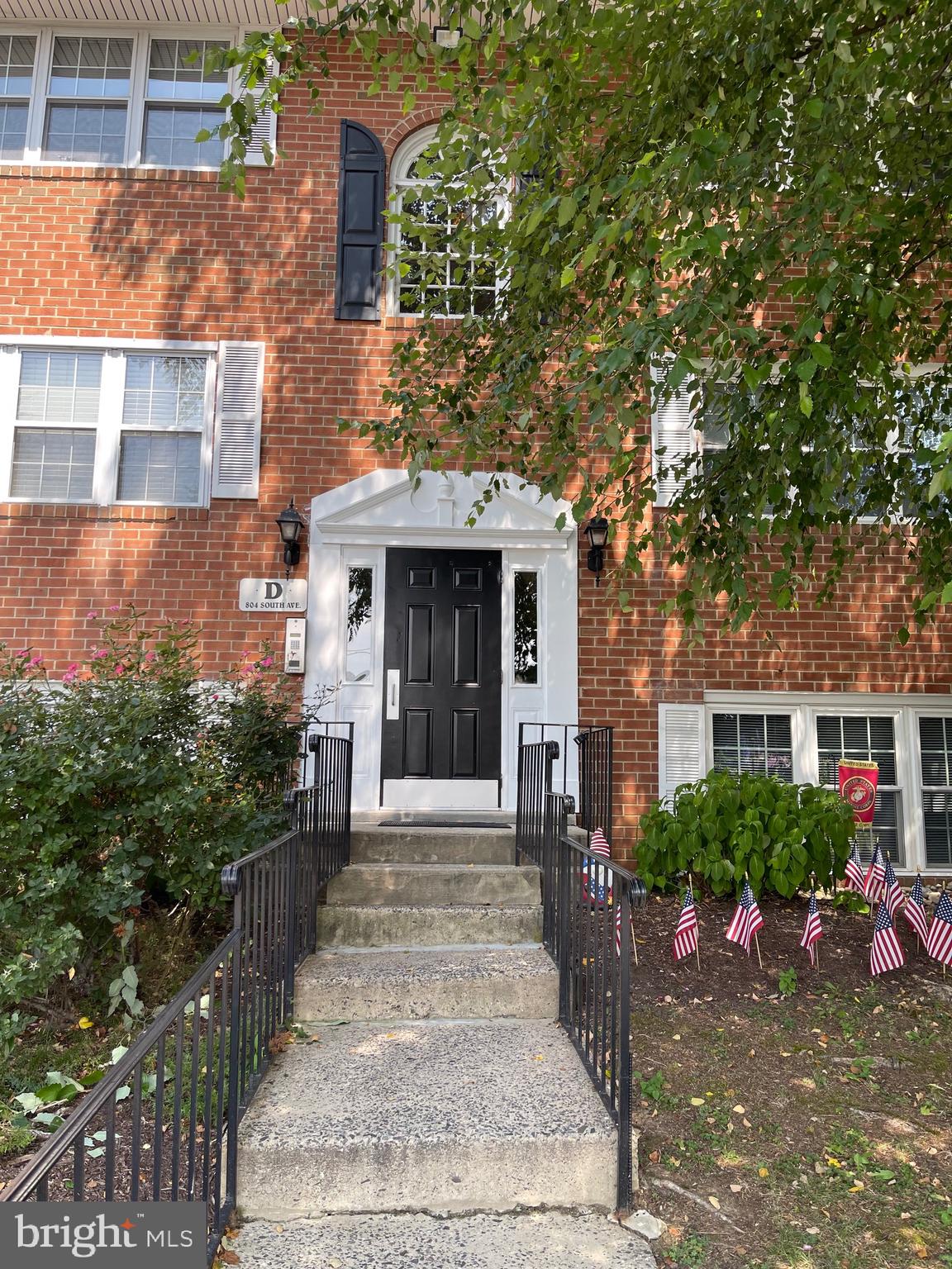804 South Avenue, Unit D7 Secane, PA 19018 - Photo 3 of 33 a front view of a house with a yard and potted plants