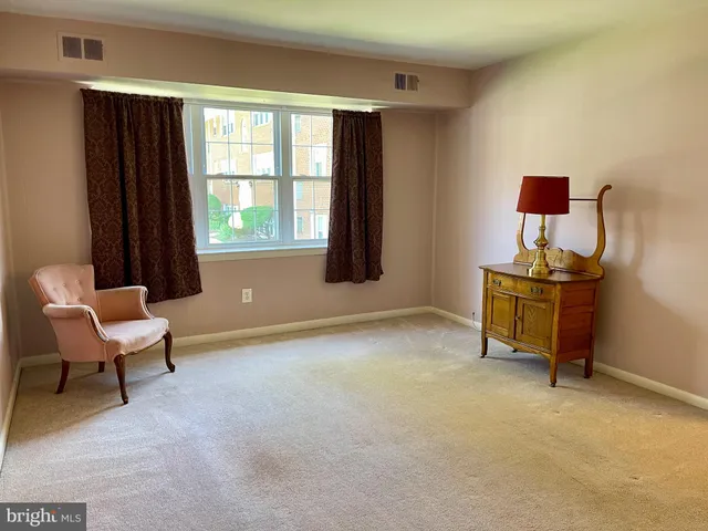 a view of dining room with furniture and a chandelier