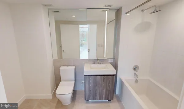 a bathroom with a toilet a sink and bathtub