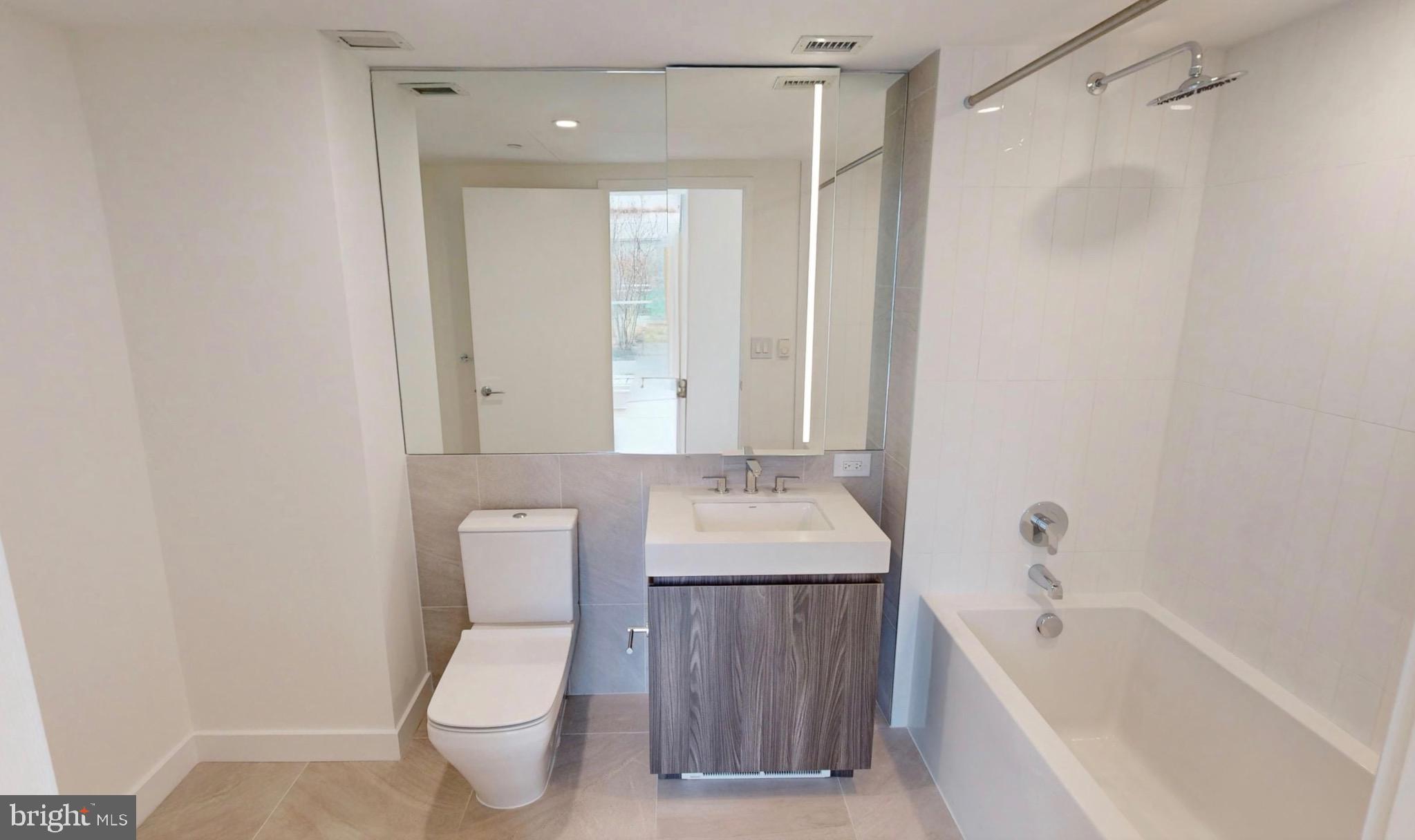 1201 Half Street Southwest, Unit PH1201 Washington, DC 20003 - Photo 13 of 26 a bathroom with a toilet a sink and bathtub