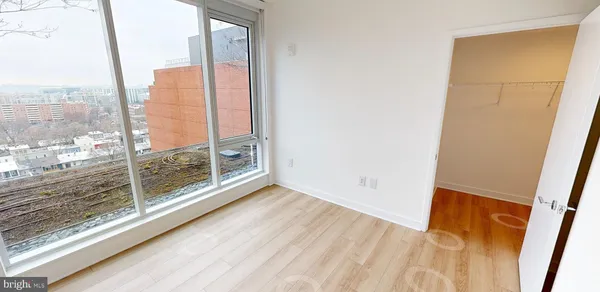 a view of a room with wooden floor and windows
