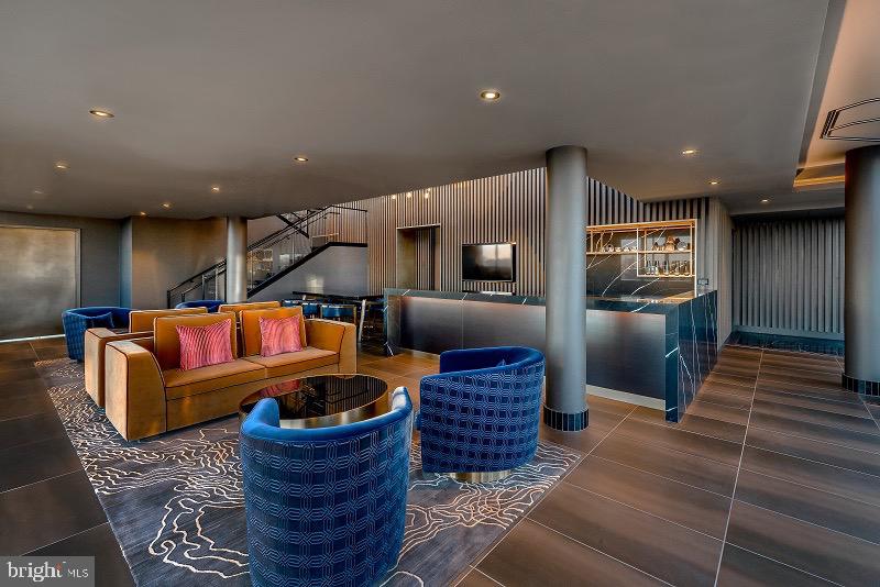 1201 Half Street Southwest, Unit PH1201 Washington, DC 20003 - Photo 21 of 26 a living room with furniture and a rug