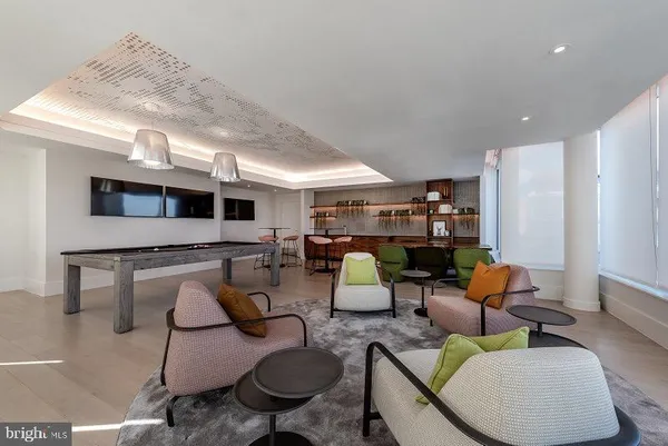 a living room with furniture and a floor to ceiling window