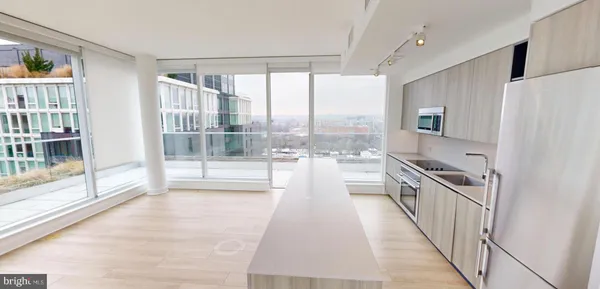 a view of a kitchen with a sink and cabinets