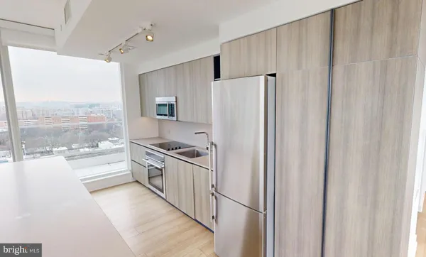 a large white kitchen with a large window