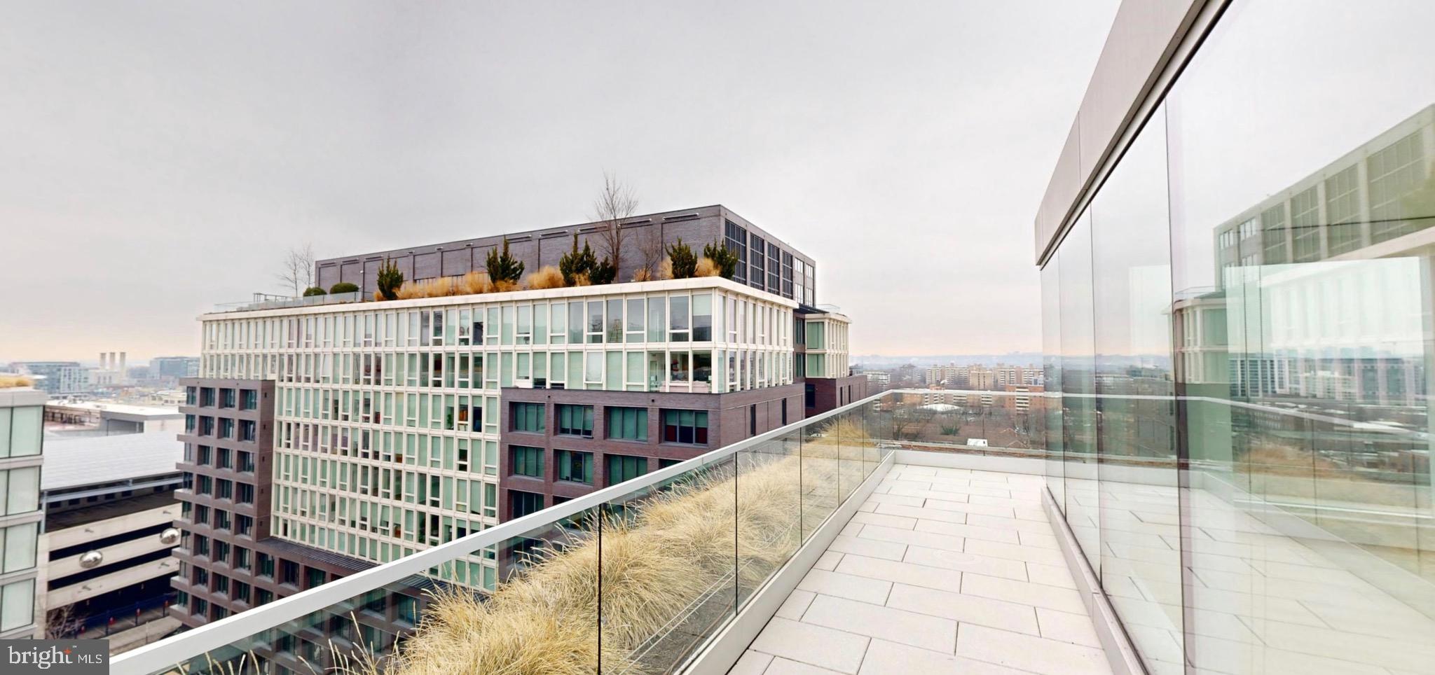 1201 Half Street Southwest, Unit PH1201 Washington, DC 20003 - Photo 8 of 26 a view of balcony with a large window and wooden floor