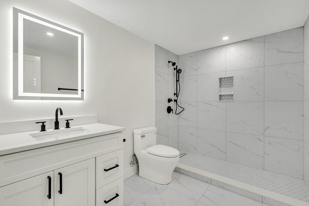 22 Estabrook Road Lexington, MA 02421 - Photo 18 of 35 a bathroom with a granite countertop sink a toilet and a mirror