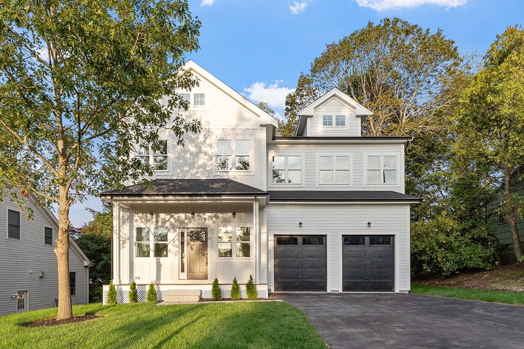 22 Estabrook Road Lexington, MA 02421 - Photo 2 of 35 a view of a white house with a large windows and a yard with plants and large trees