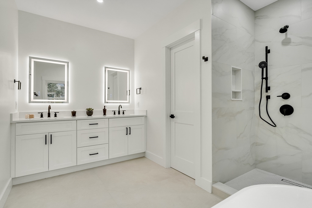 22 Estabrook Road Lexington, MA 02421 - Photo 25 of 35 a spacious bathroom with a shower sink and mirror