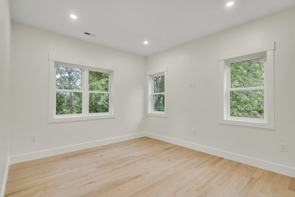 22 Estabrook Road Lexington, MA 02421 - Photo 26 of 35 an empty room with wooden floor and windows