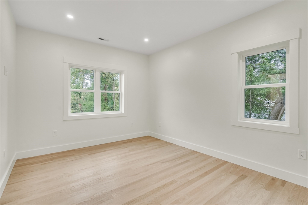 22 Estabrook Road Lexington, MA 02421 - Photo 28 of 35 an empty room with wooden floor and windows