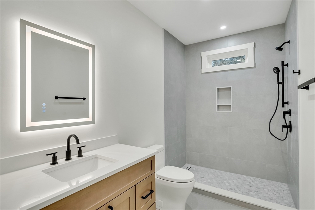 22 Estabrook Road Lexington, MA 02421 - Photo 30 of 35 a bathroom with a granite countertop sink toilet and shower