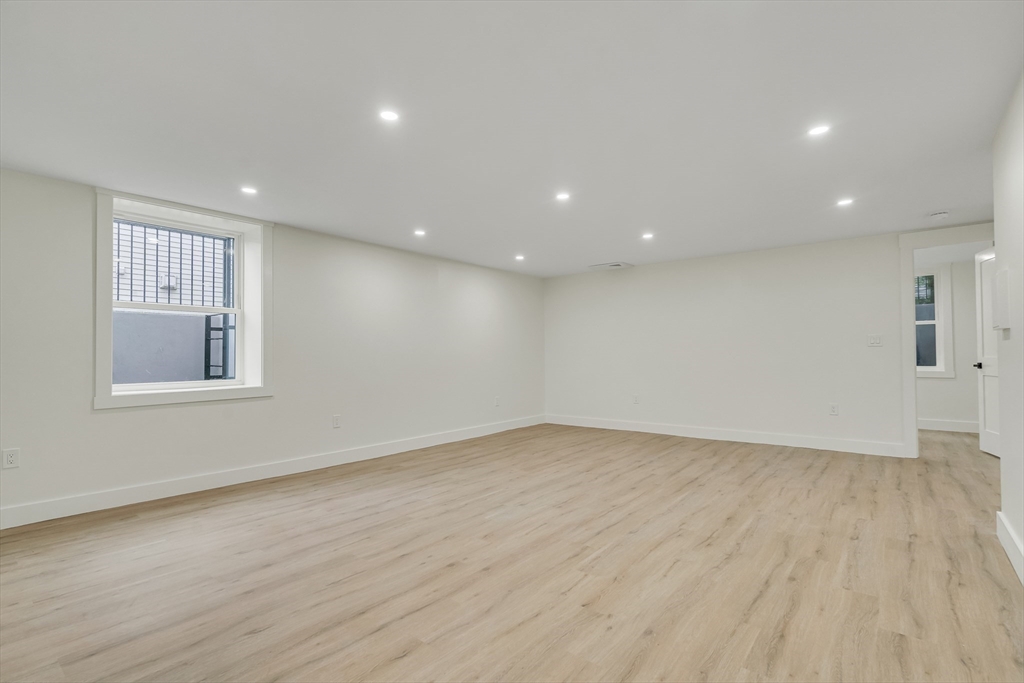 22 Estabrook Road Lexington, MA 02421 - Photo 32 of 35 an empty room with wooden floor and windows