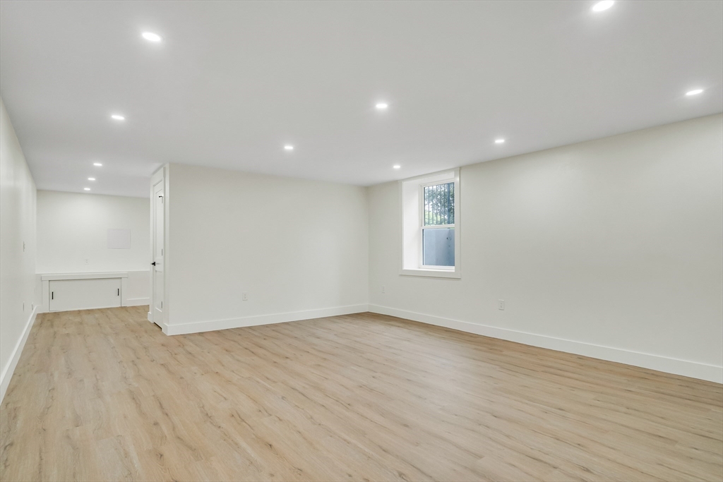 22 Estabrook Road Lexington, MA 02421 - Photo 33 of 35 an empty room with wooden floor and windows