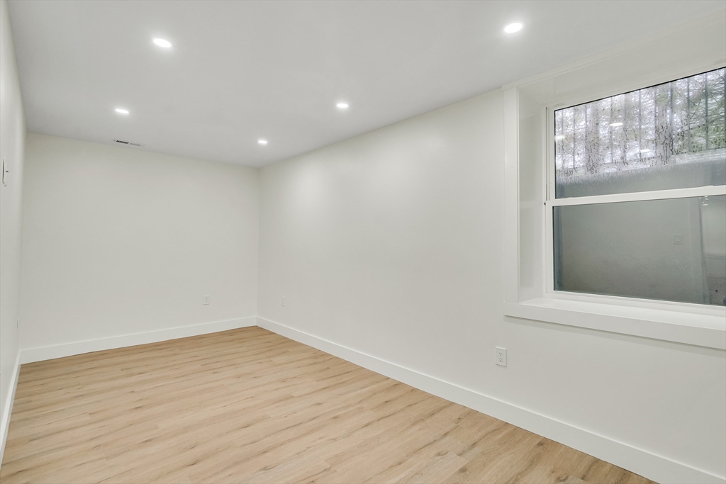 22 Estabrook Road Lexington, MA 02421 - Photo 34 of 35 a view of empty room with wooden floor and fan