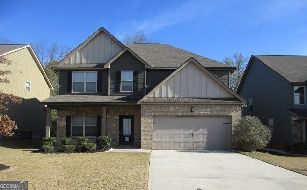 1155 Hartwell Road Locust Grove, GA 30248 - Photo 1 of 1 a front view of a house with a yard and garage