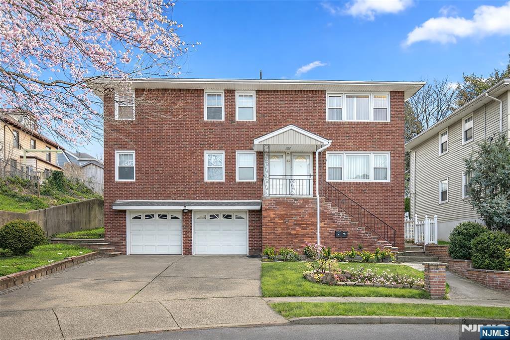 a front view of a house with a yard and outdoor seating