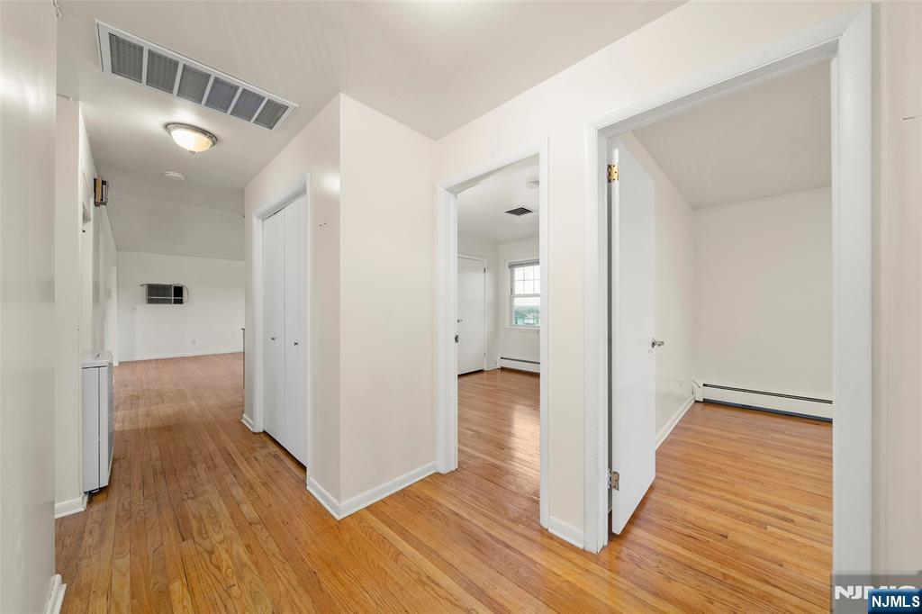 410 Mayer Court Ridgefield, NJ 07657 - Photo 11 of 22 a view of a hallway with wooden floor