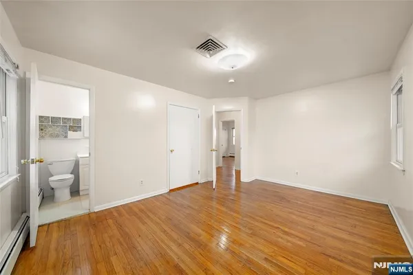 a big room with wooden floor and windows