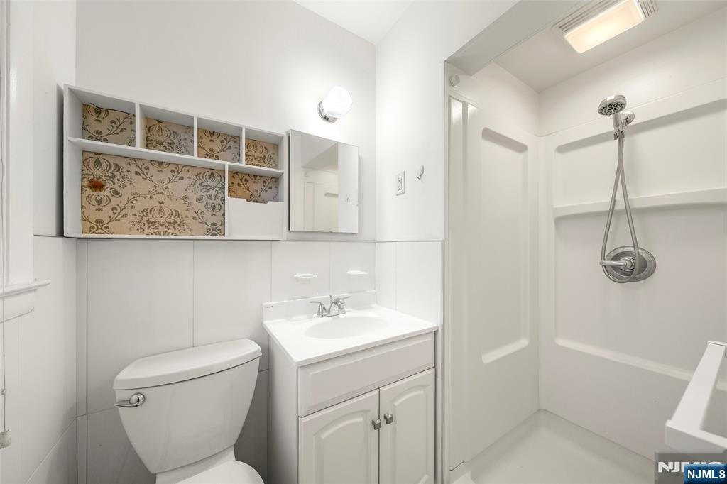 410 Mayer Court Ridgefield, NJ 07657 - Photo 14 of 22 a bathroom with a toilet sink and mirror