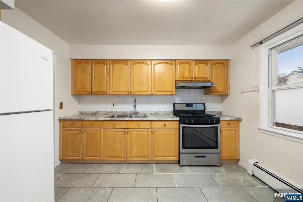 410 Mayer Court Ridgefield, NJ 07657 - Photo 8 of 22 a kitchen with stainless steel appliances granite countertop a stove a sink and a refrigerator
