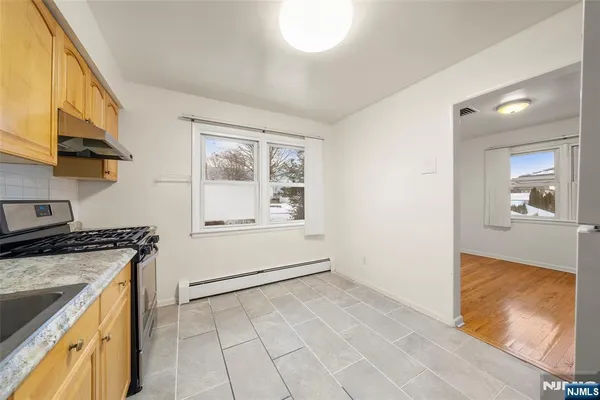 a kitchen with a stove a sink and a refrigerator