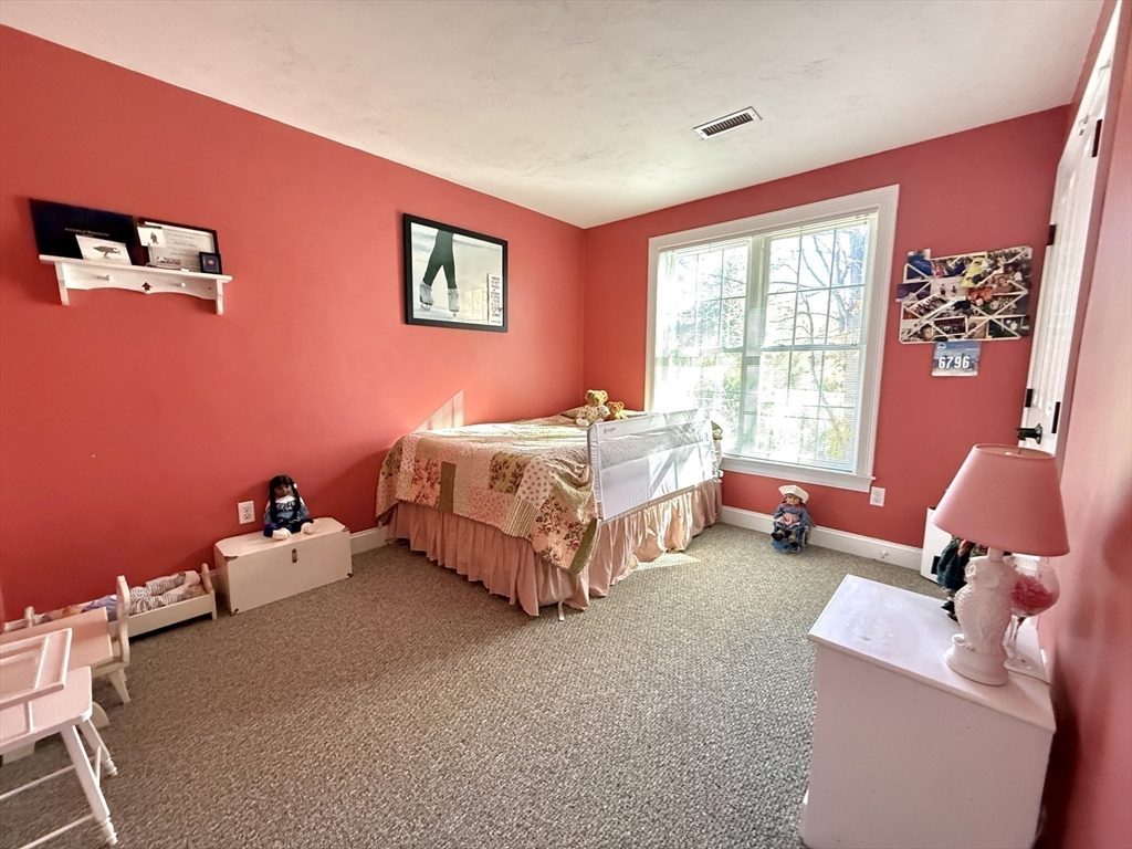 63 Providence Road, Unit 2 Grafton, MA 01519 - Photo 7 of 9 a bedroom with furniture and a large window