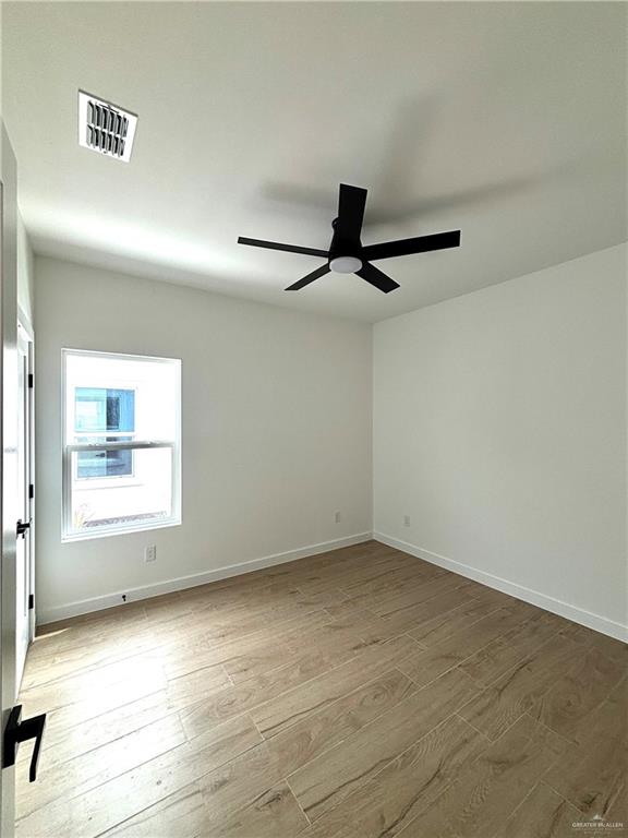4 Estevan Street Mission, TX 78573 - Photo 15 of 24 an empty room with a ceiling fan and window