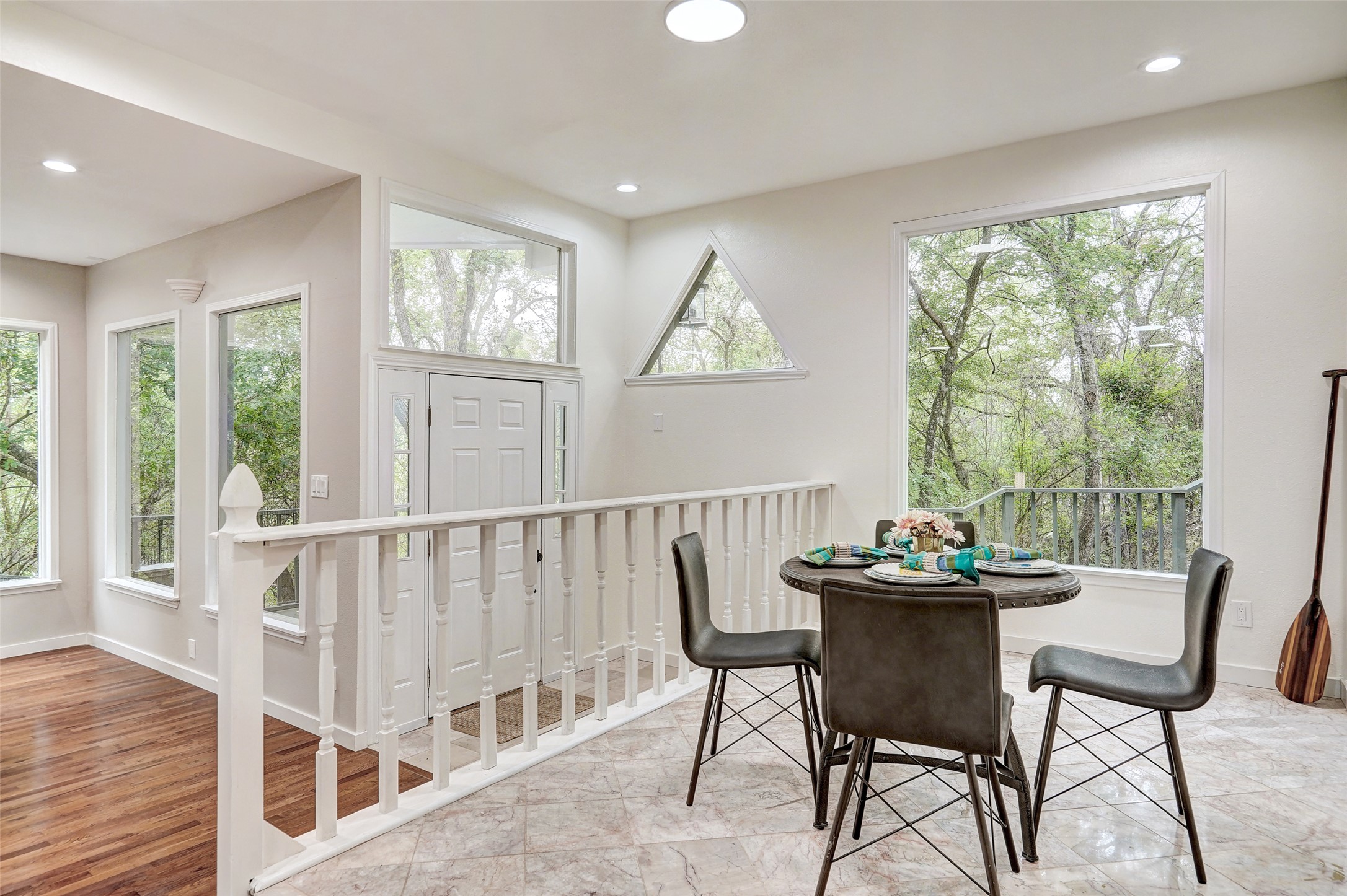 8804 Mountain Ridge Drive, Unit B Austin, TX 78759 - Photo 4 of 17 A well-lit entry and dining area offers serene tree views through generous windows.
