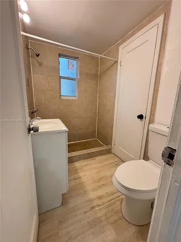 a bathroom with a toilet and a shower