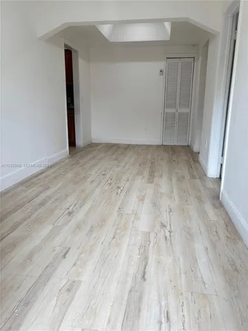 a view of room with wooden floor