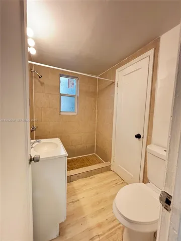 a bathroom with a toilet and a shower