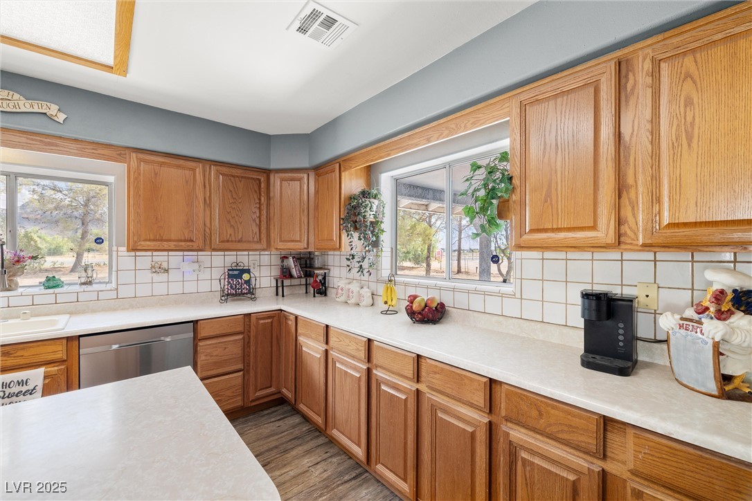 3951 West Blosser Ranch Road Pahrump, NV 89060 - Photo 12 of 35 Kitchen with dishwasher, light countertops, and backsplash