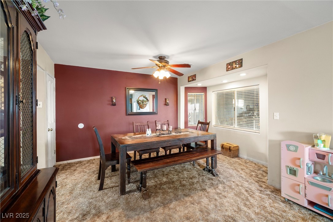 3951 West Blosser Ranch Road Pahrump, NV 89060 - Photo 15 of 35 Carpeted dining room with ceiling fan and baseboards