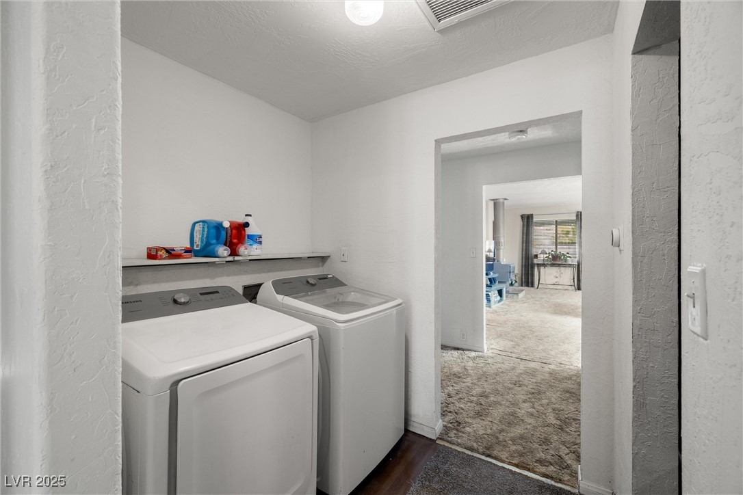 3951 West Blosser Ranch Road Pahrump, NV 89060 - Photo 16 of 35 Washroom with washer and dryer, dark wood-style floors, and a textured wall