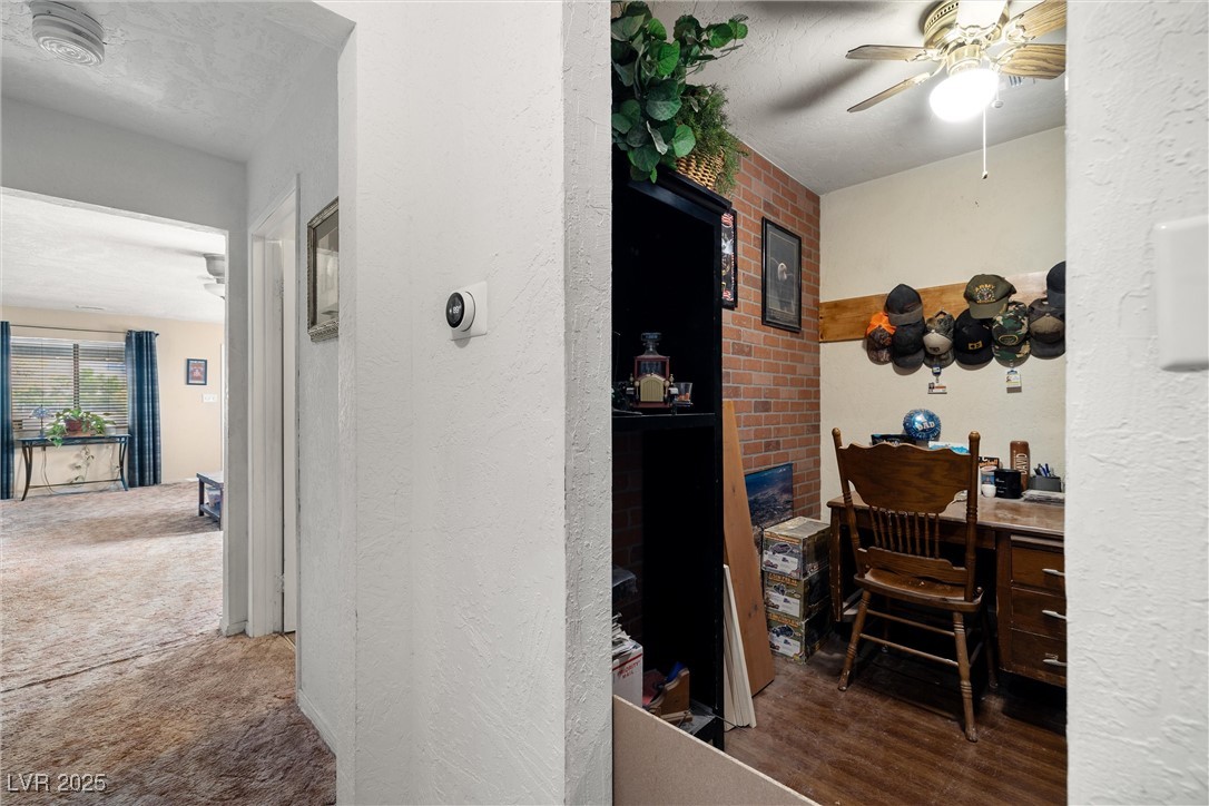 3951 West Blosser Ranch Road Pahrump, NV 89060 - Photo 17 of 35 Hall with carpet floors and a textured wall