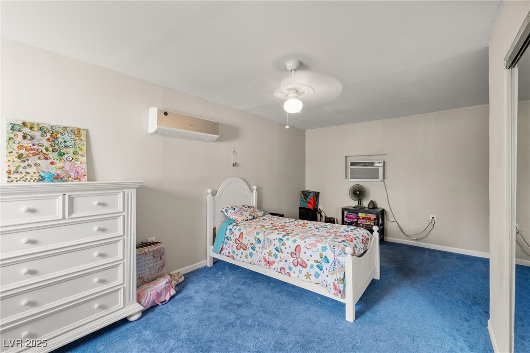 3951 West Blosser Ranch Road Pahrump, NV 89060 - Photo 19 of 35 Bedroom with a wall mounted AC, carpet floors, ceiling fan, and an AC wall unit