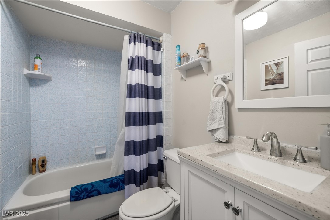 3951 West Blosser Ranch Road Pahrump, NV 89060 - Photo 20 of 35 Bathroom featuring vanity and shower / bath combo with shower curtain