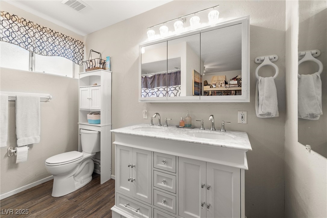 3951 West Blosser Ranch Road Pahrump, NV 89060 - Photo 22 of 35 Full bath with double vanity, wood finished floors, and curtained shower