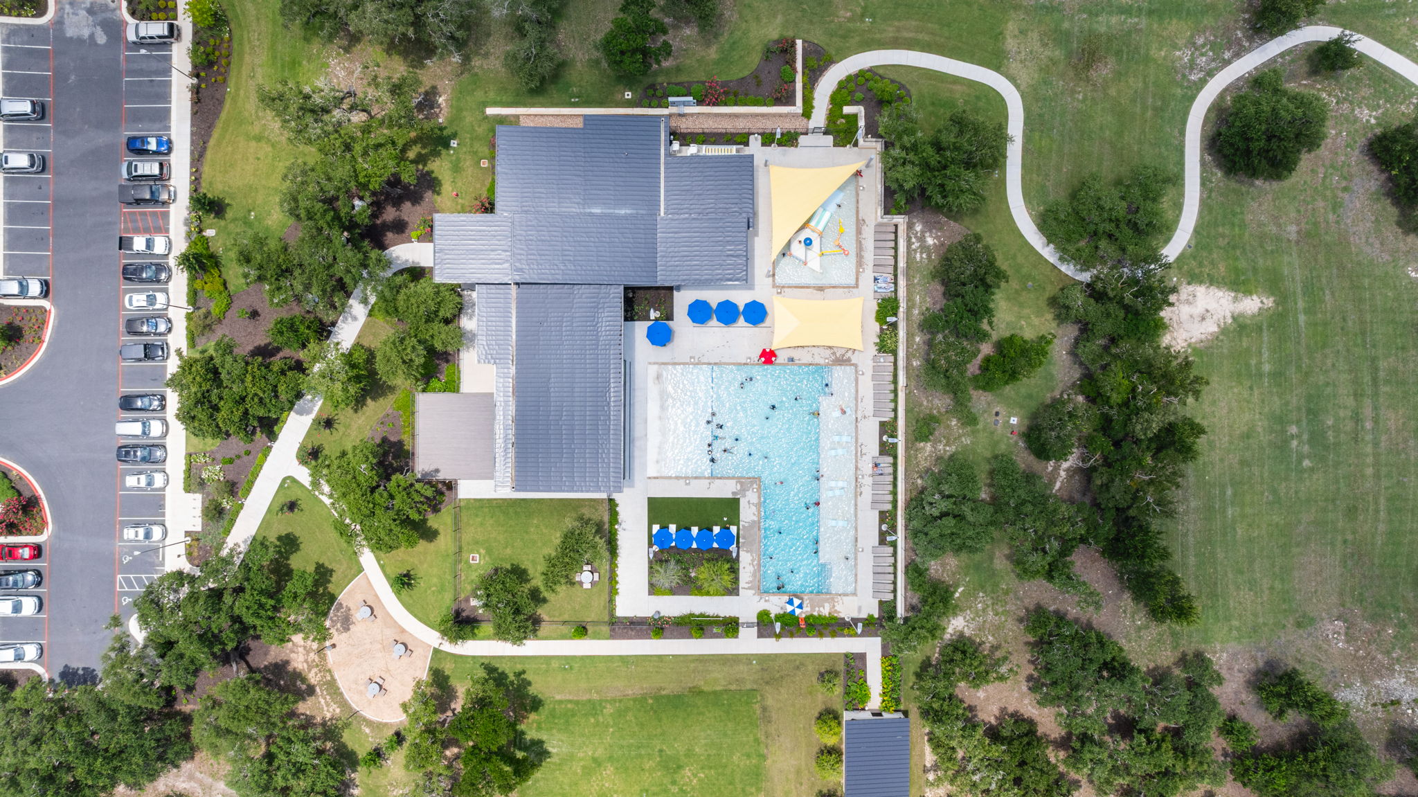 313 Mclintock Road Jarrell, TX 76537 - Photo 38 of 40 An aerial perspective reveals the vibrant community pool and surrounding green spaces.