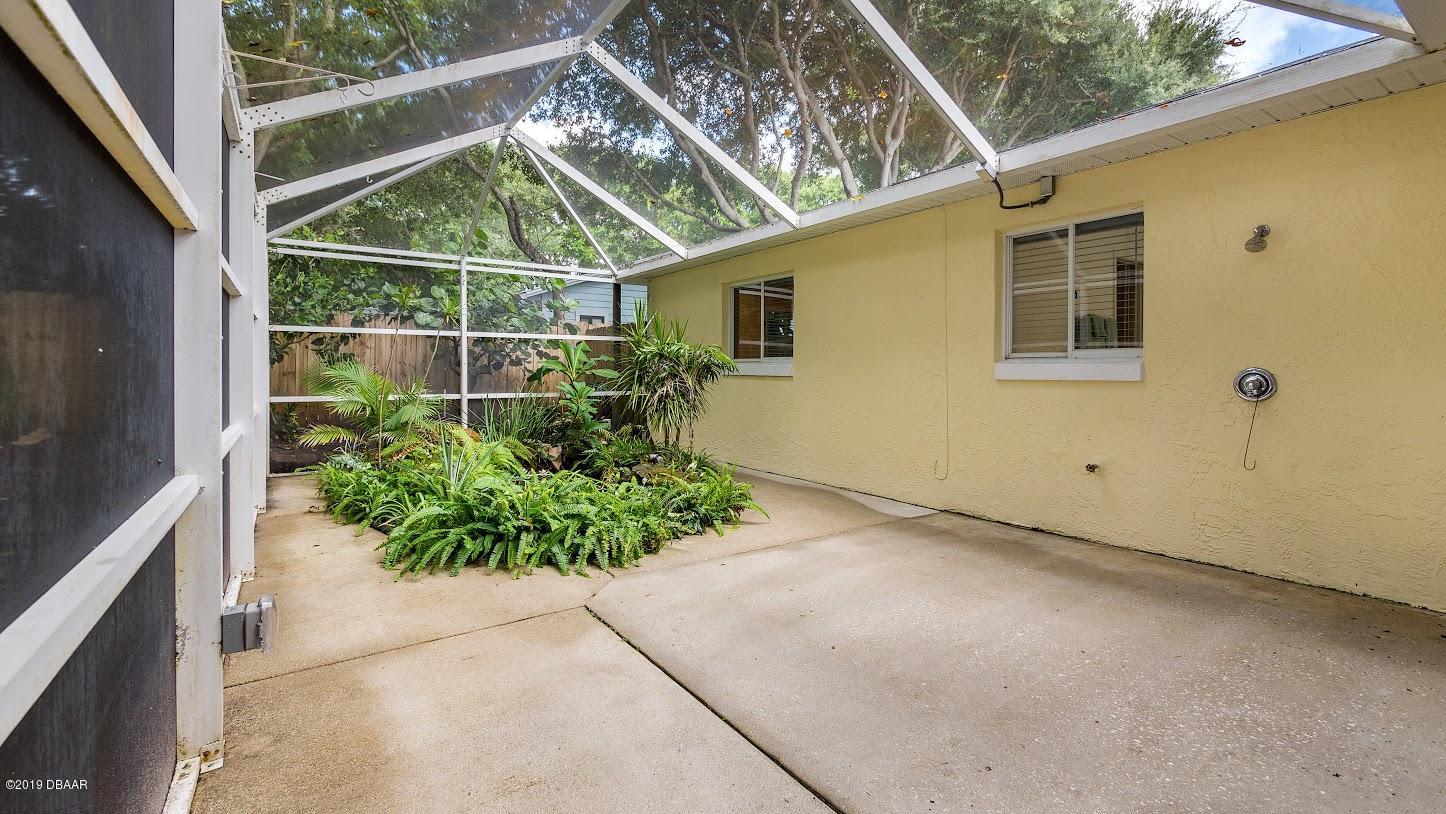 73 Glenview Avenue Ponce Inlet, FL 32127 - Photo 29 of 36 Back Patio with pond